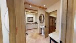 Master bathroom with walk in closet, granite counter tops and dual sinks 